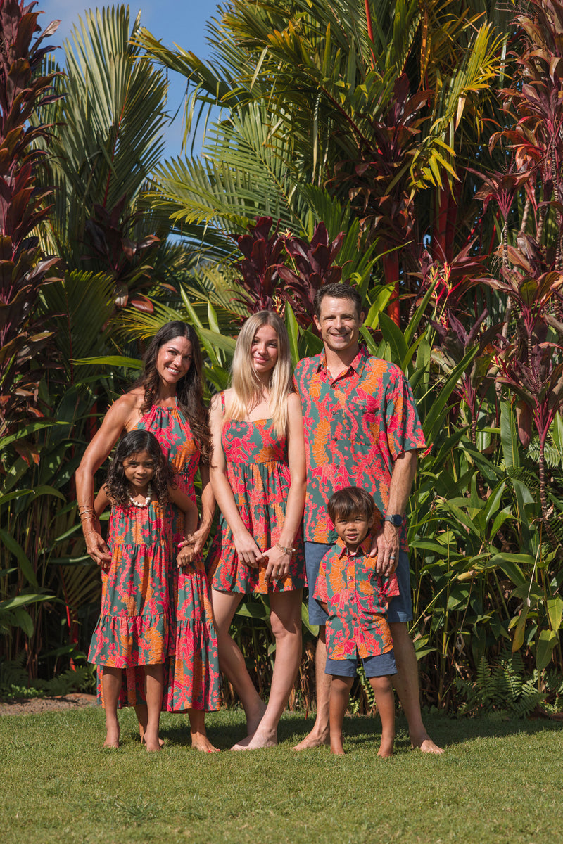 family wearing a colorful matching set with tropical lei printing