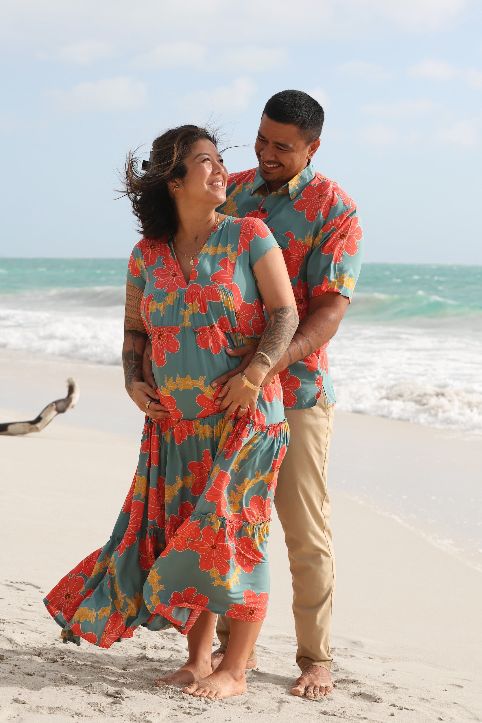 man wearing green button up shirt with orange and yellow lei pua print