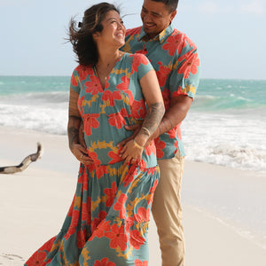 man wearing green button up shirt with orange and yellow lei pua print