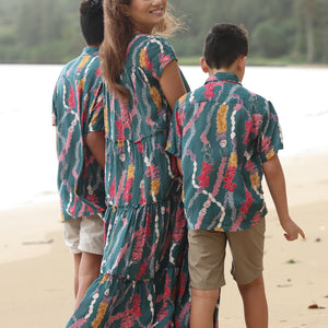 little boy wearing aloha button up shirt in dark teal with shell and lei print