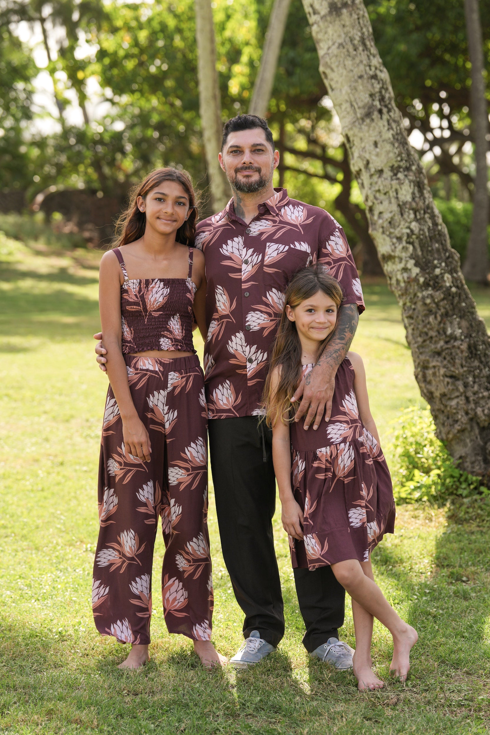 man wearing brown button up aloha shirt with protea print