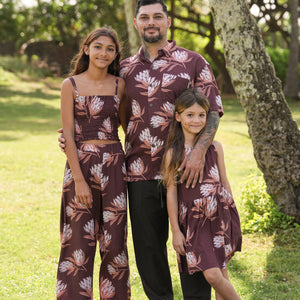 man wearing brown button up aloha shirt with protea print
