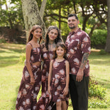 man wearing brown button up aloha shirt with protea print