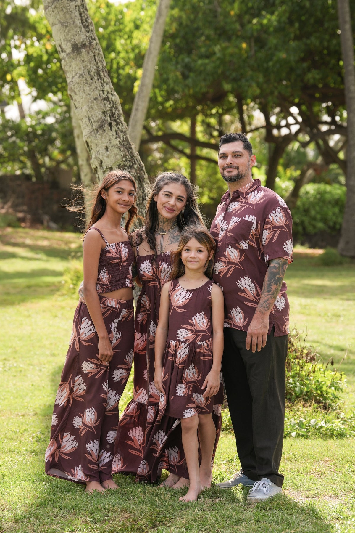 man wearing brown button up aloha shirt with protea print