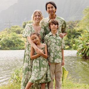 little boy wearing green aloha shirt with native Hawaiian plants