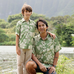 little boy wearing green aloha shirt with native Hawaiian plants