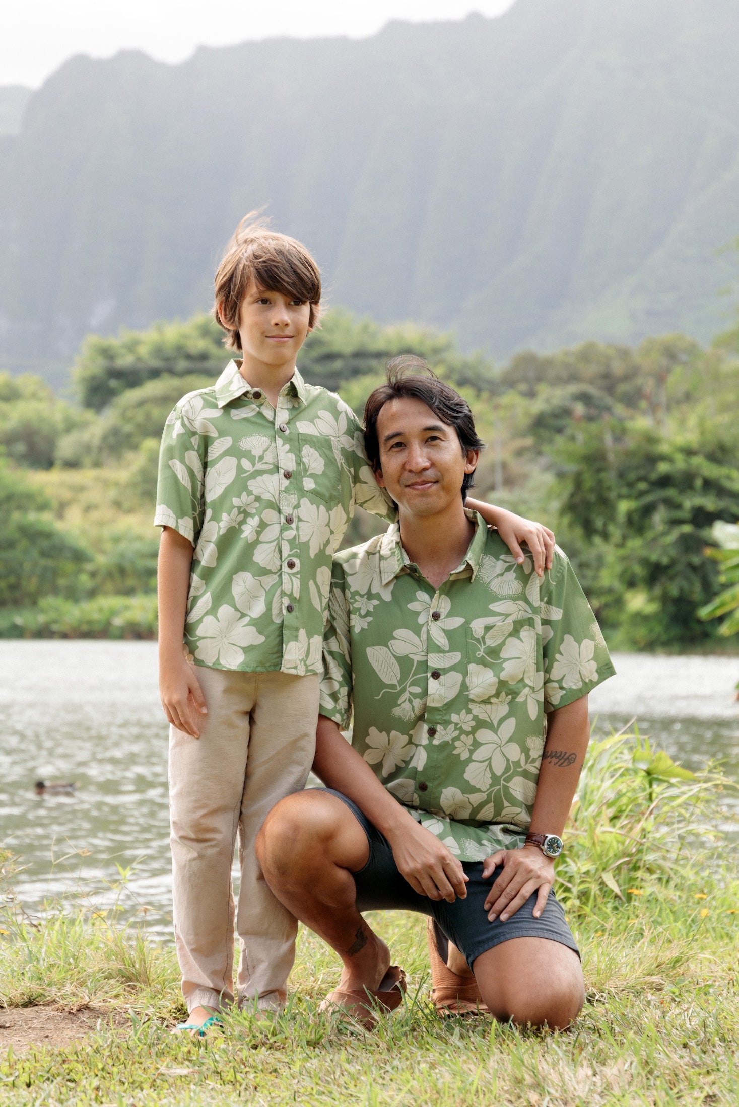 man wearing green aloha button up shirt with Native Hawaiian plant pattern