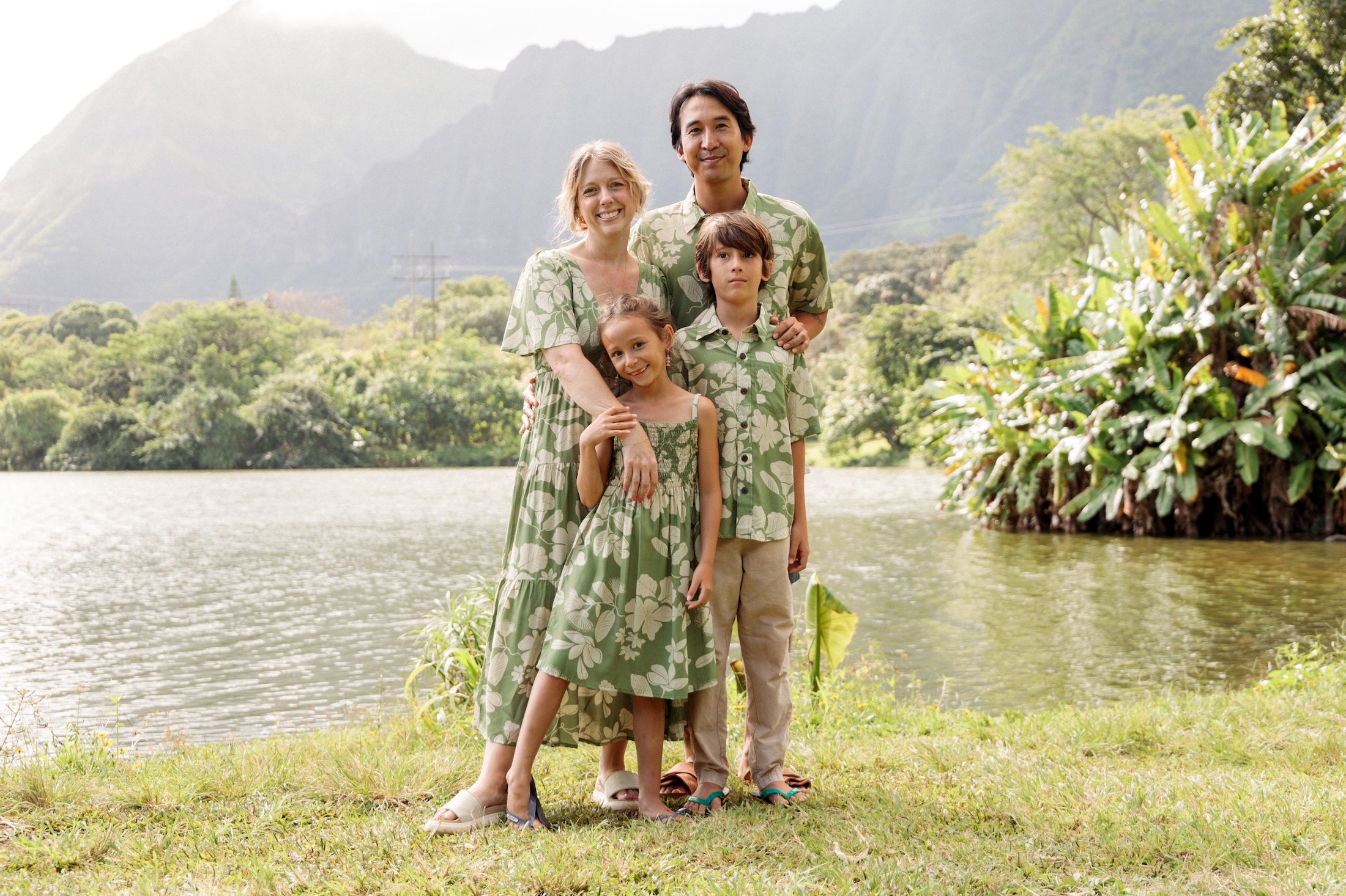 man wearing green aloha button up shirt with Native Hawaiian plant pattern