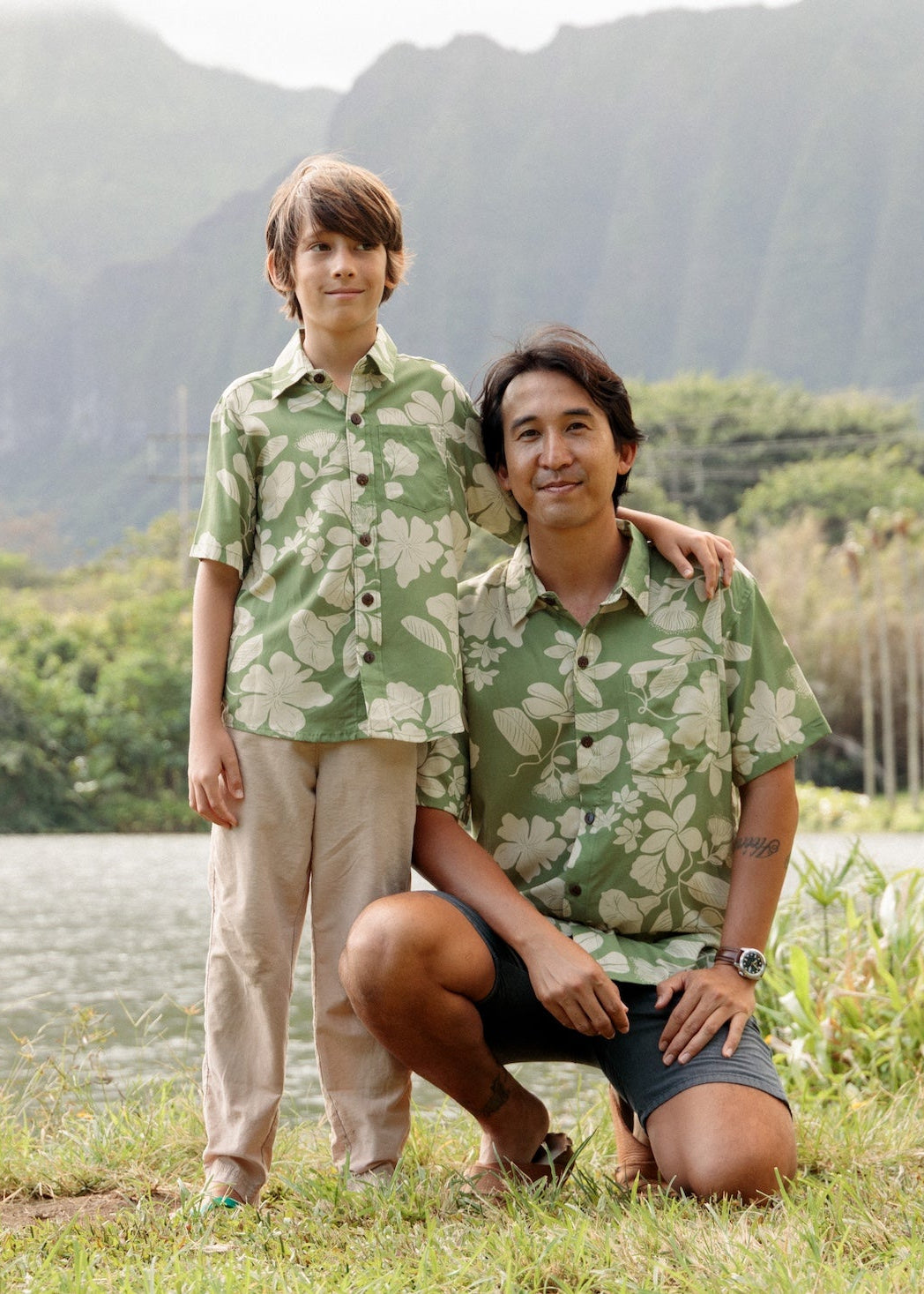 man wearing green aloha button up shirt with Native Hawaiian plant pattern