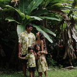 family wearing matching aloha wear in green print with naupaka pattern