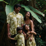 family wearing matching aloha wear in green print with naupaka pattern