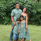 man wearing lush green aloha button-up shirt with pua kenikeni print