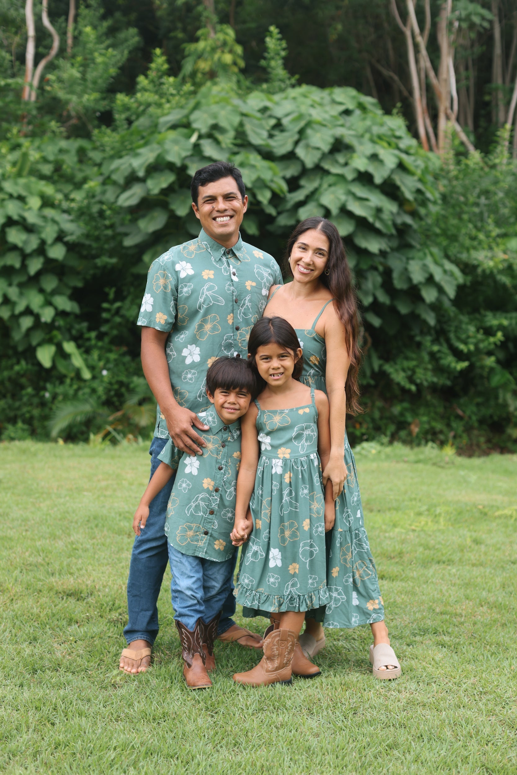 man wearing lush green aloha button-up shirt with pua kenikeni print