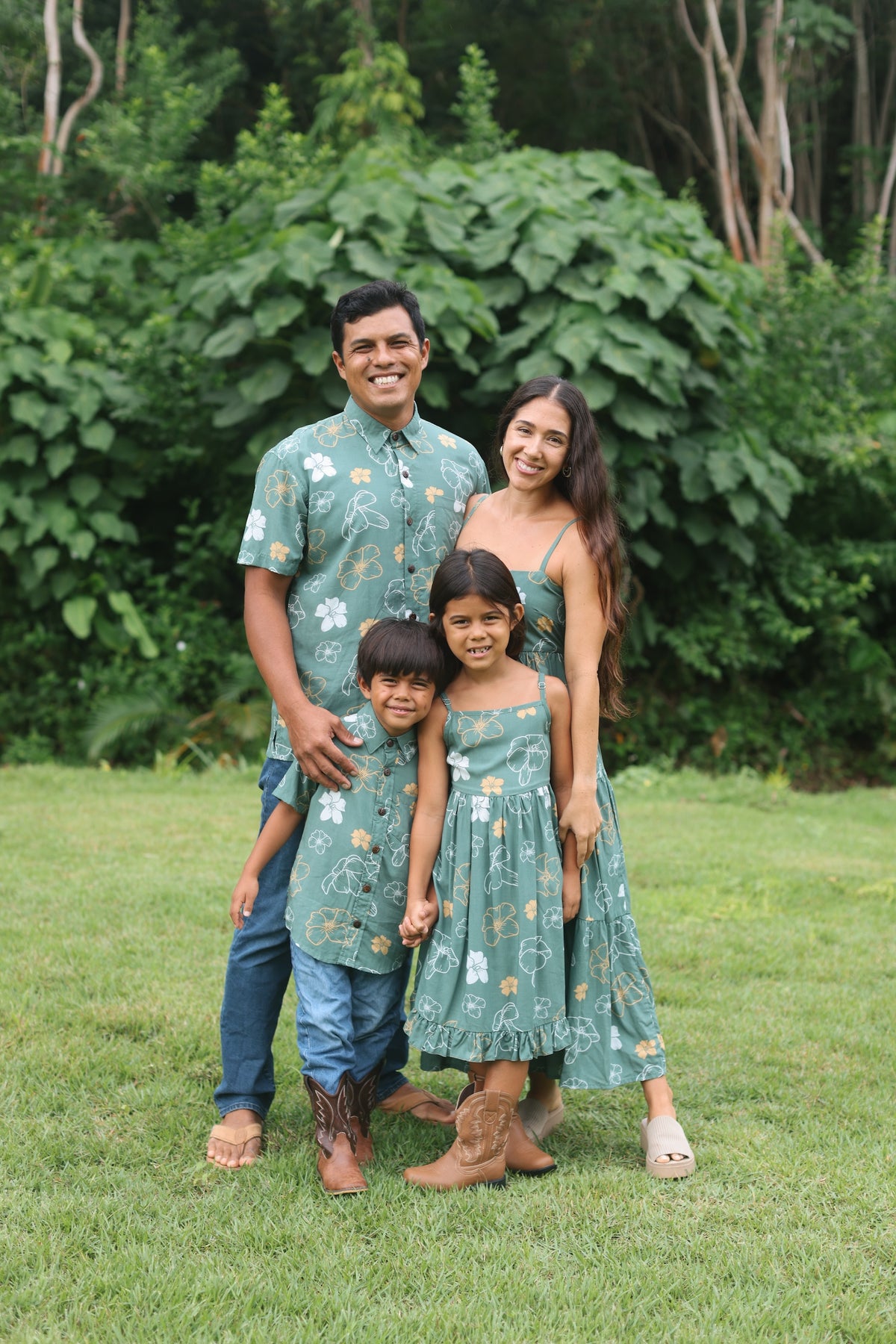 man wearing lush green aloha button-up shirt with pua kenikeni print