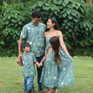 man wearing lush green aloha button-up shirt with pua kenikeni print