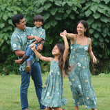 man wearing lush green aloha button-up shirt with pua kenikeni print