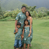 man wearing lush green aloha button-up shirt with pua kenikeni print