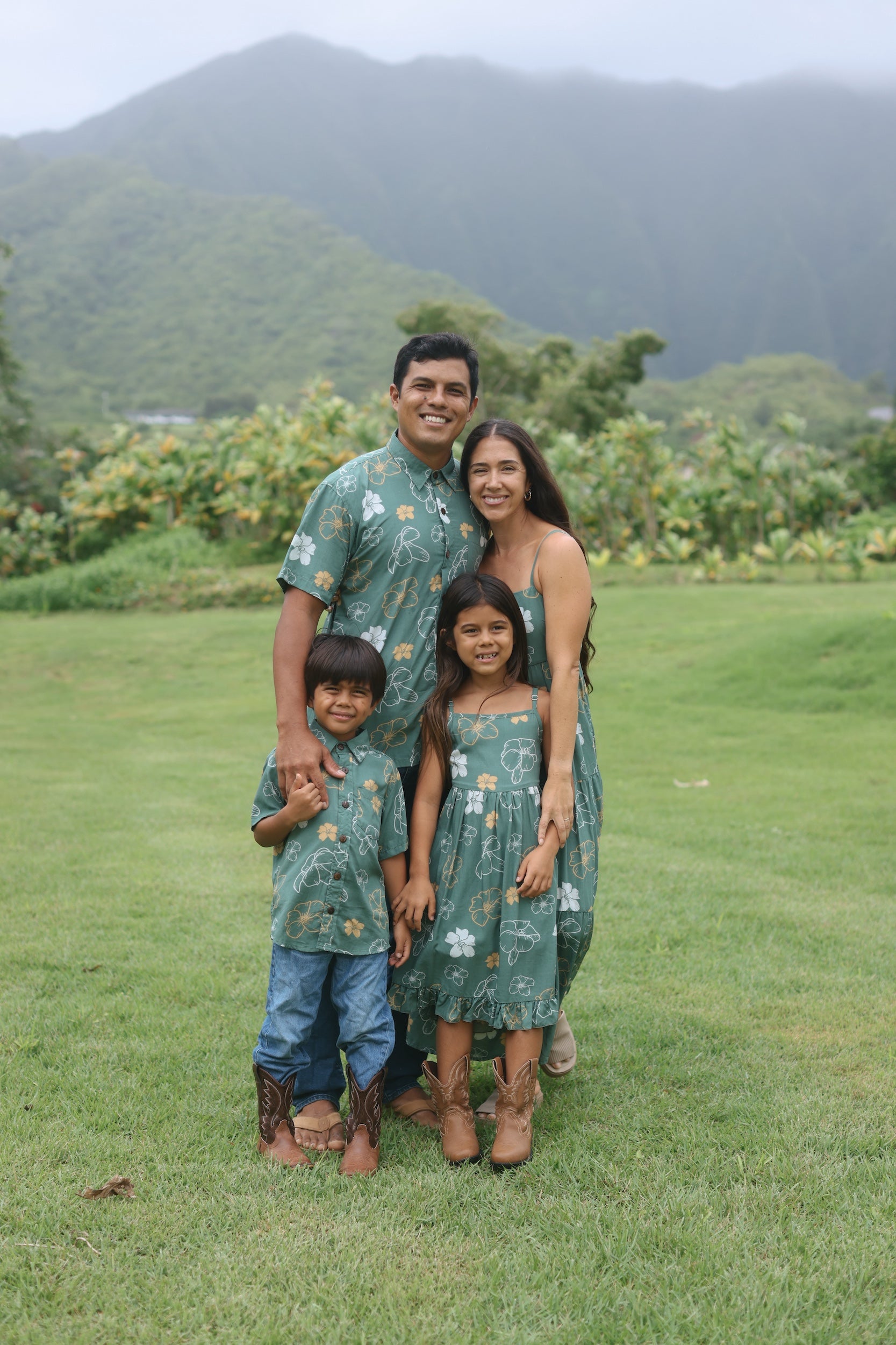 man wearing lush green aloha button-up shirt with pua kenikeni print