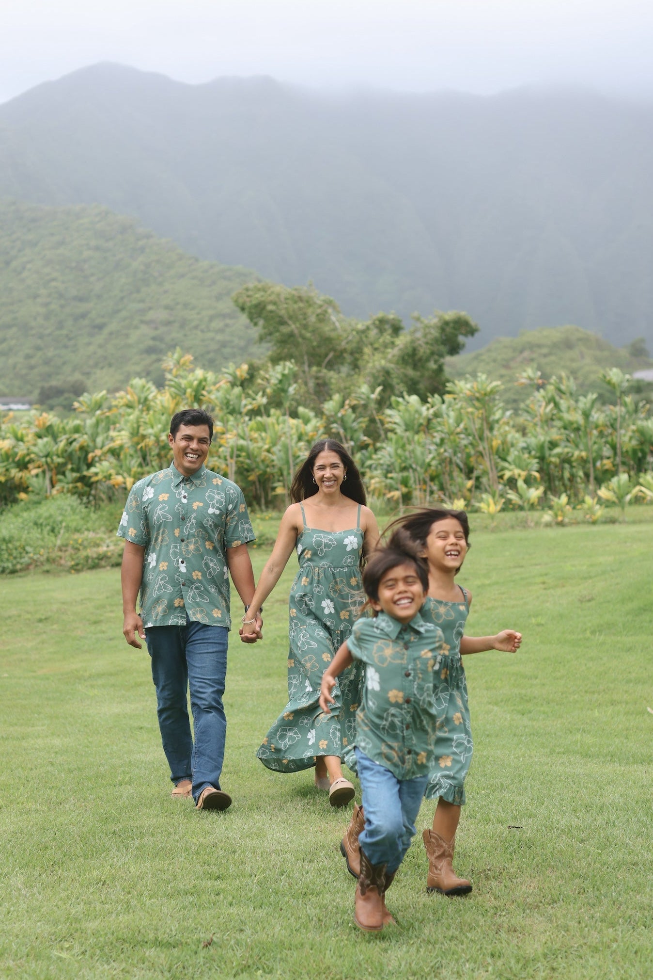 man wearing lush green aloha button-up shirt with pua kenikeni print
