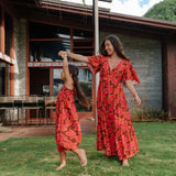 little girl wearing jumpsuit with retro pink pua pattern