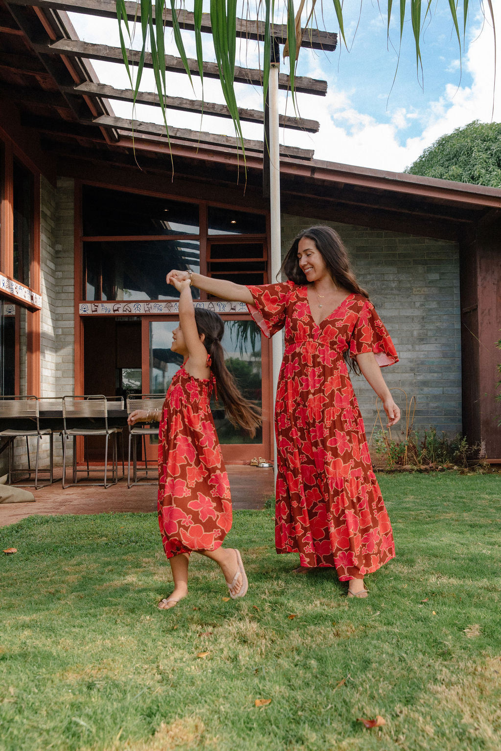 little girl wearing jumpsuit with retro pink pua pattern