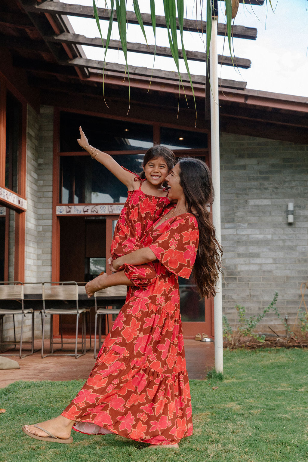 little girl wearing jumpsuit with retro pink pua pattern