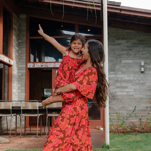 little girl wearing jumpsuit with retro pink pua pattern