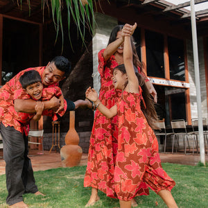 little girl wearing jumpsuit with retro pink pua pattern