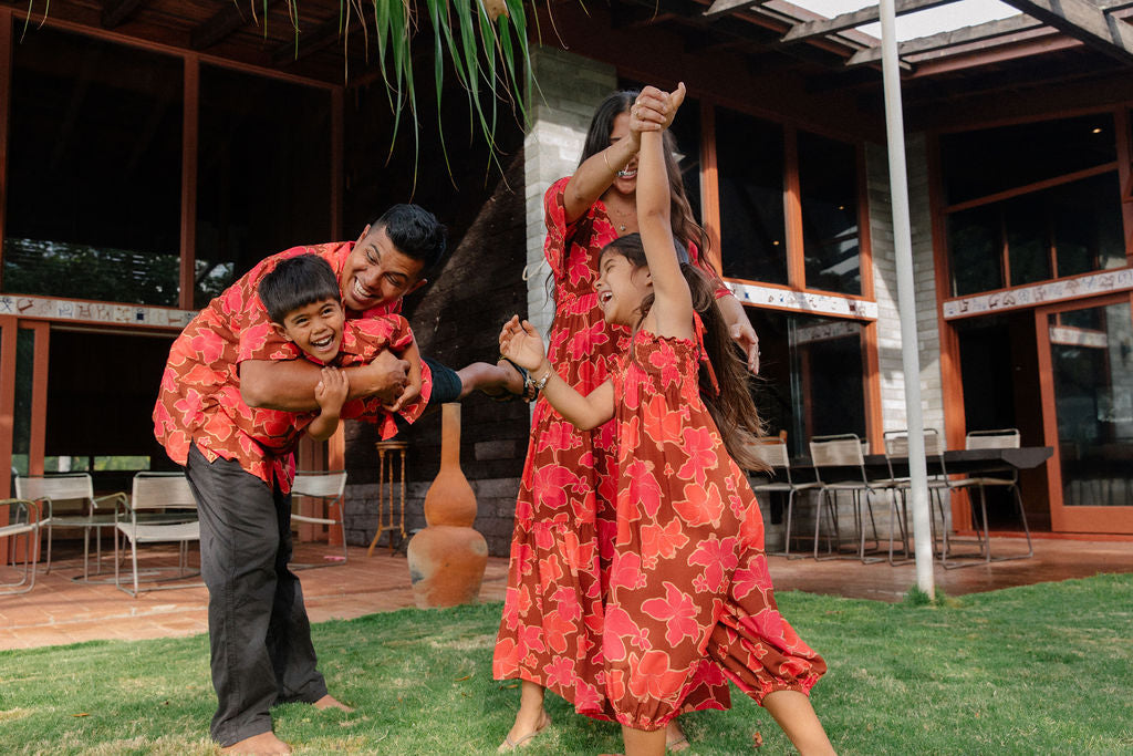 little girl wearing jumpsuit with retro pink pua pattern