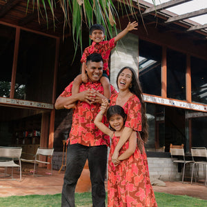 man wearing aloha shirt with vibrant pink pua pattern
