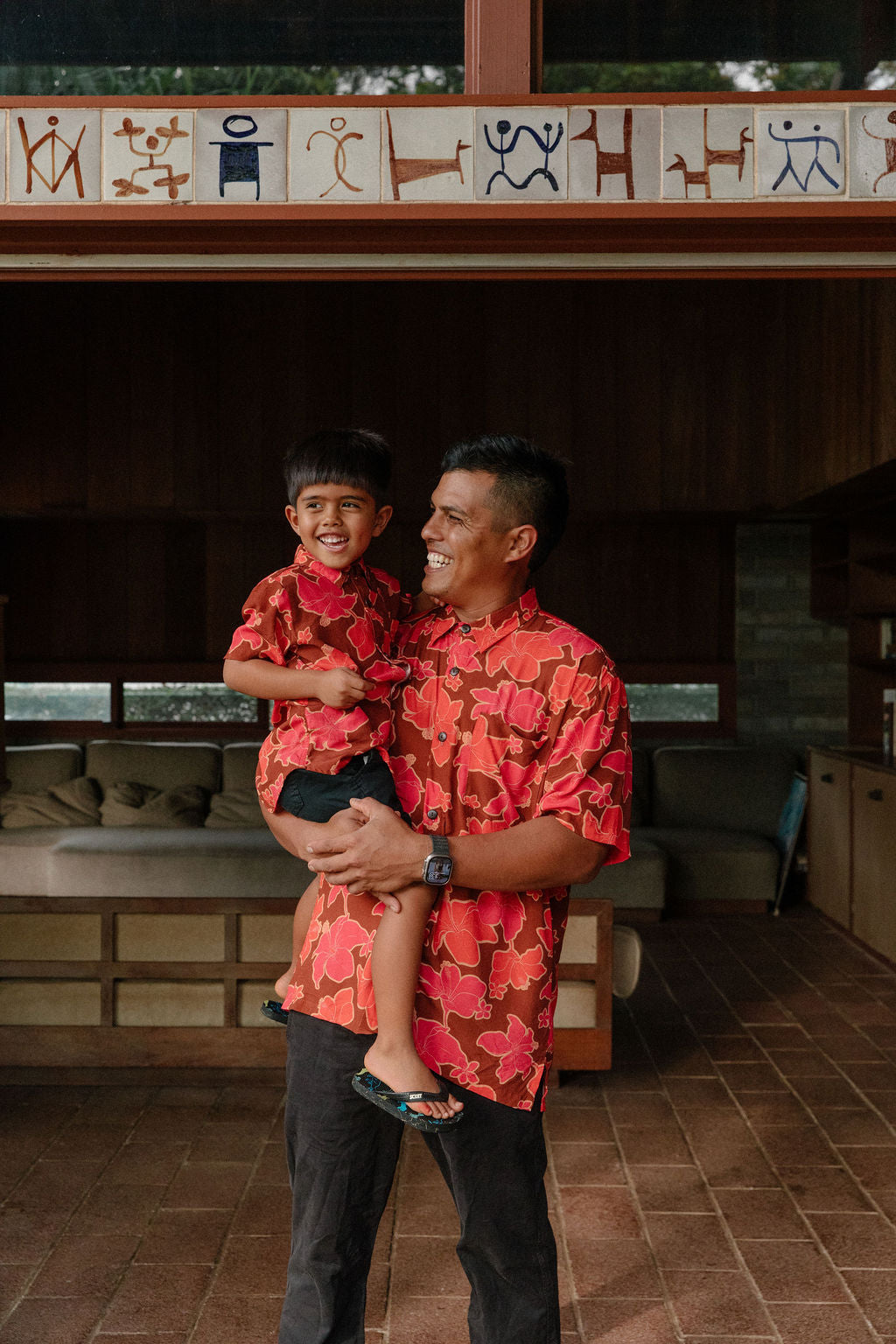 man wearing aloha shirt with vibrant pink pua pattern