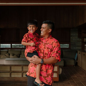 man wearing aloha shirt with vibrant pink pua pattern