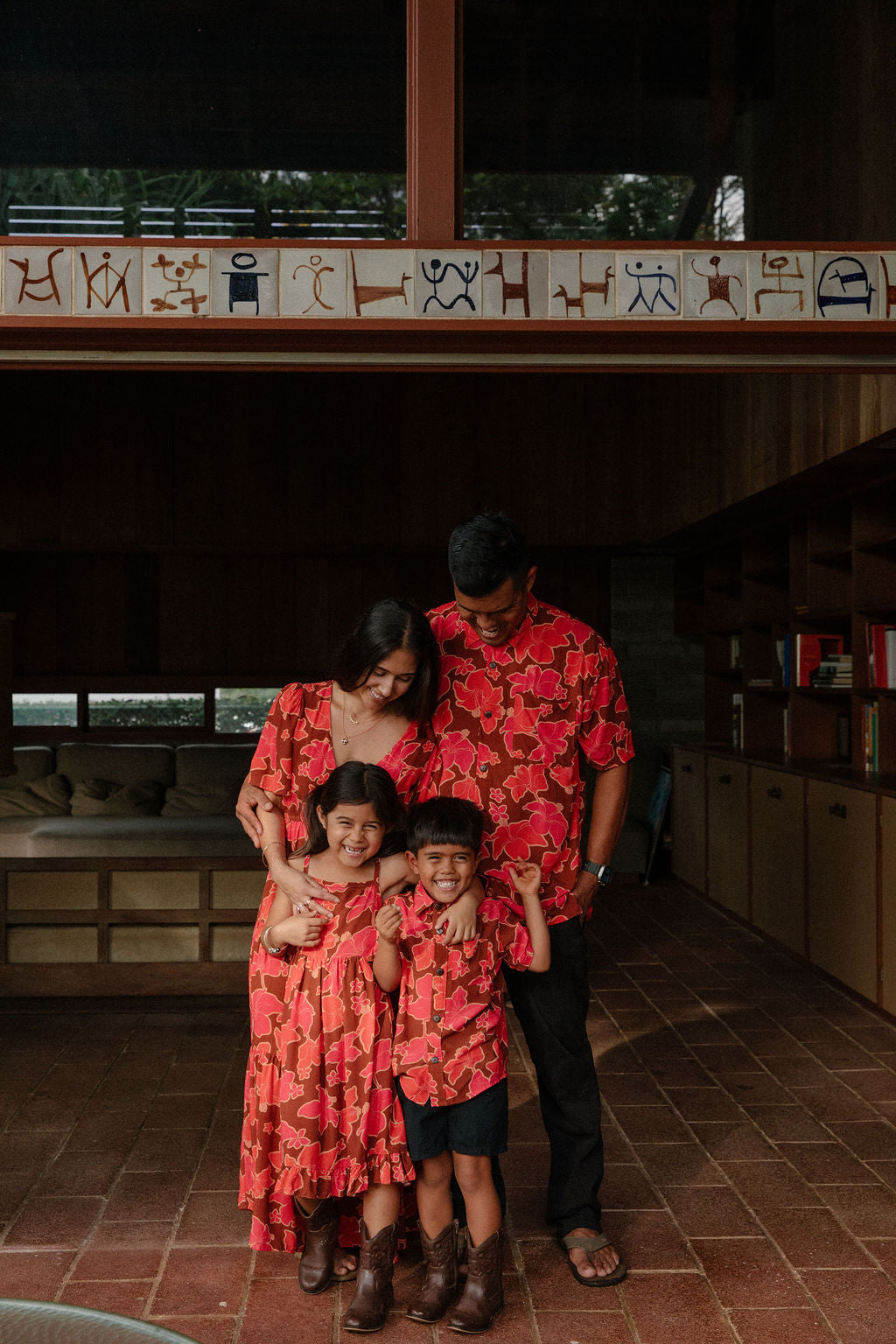little girl wearing tie back dress with retro pink pua pattern