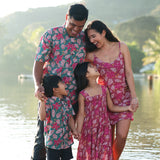 man wearing a teal aloha shirt with shell and pua print