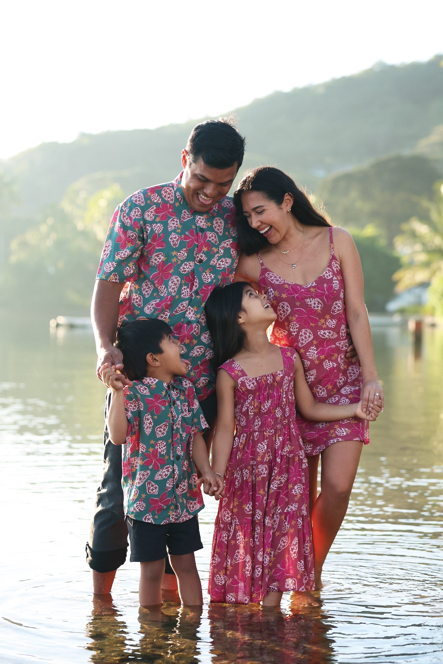 man wearing a teal aloha shirt with shell and pua print