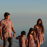 man wearing a teal aloha shirt with shell and pua print