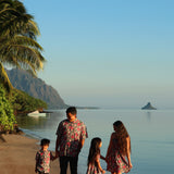 man wearing a teal aloha shirt with shell and pua print