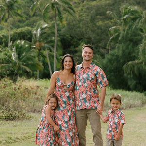 little boy wearing an aloha button up shirt with red ginger and tiare print