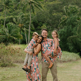 man wearing an aloha button up shirt with red ginger and tiare print