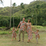 man wearing an aloha button up shirt with red ginger and tiare print