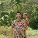 little boy wearing an aloha button up shirt with red ginger and tiare print