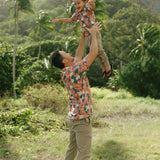 little boy wearing an aloha button up shirt with red ginger and tiare print