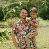 man wearing an aloha button up shirt with red ginger and tiare print