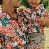little boy wearing an aloha button up shirt with red ginger and tiare print