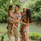 man wearing an aloha button up shirt with red ginger and tiare print