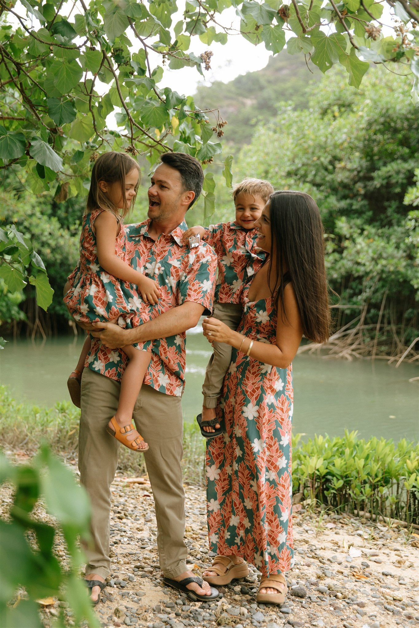 man wearing an aloha button up shirt with red ginger and tiare print