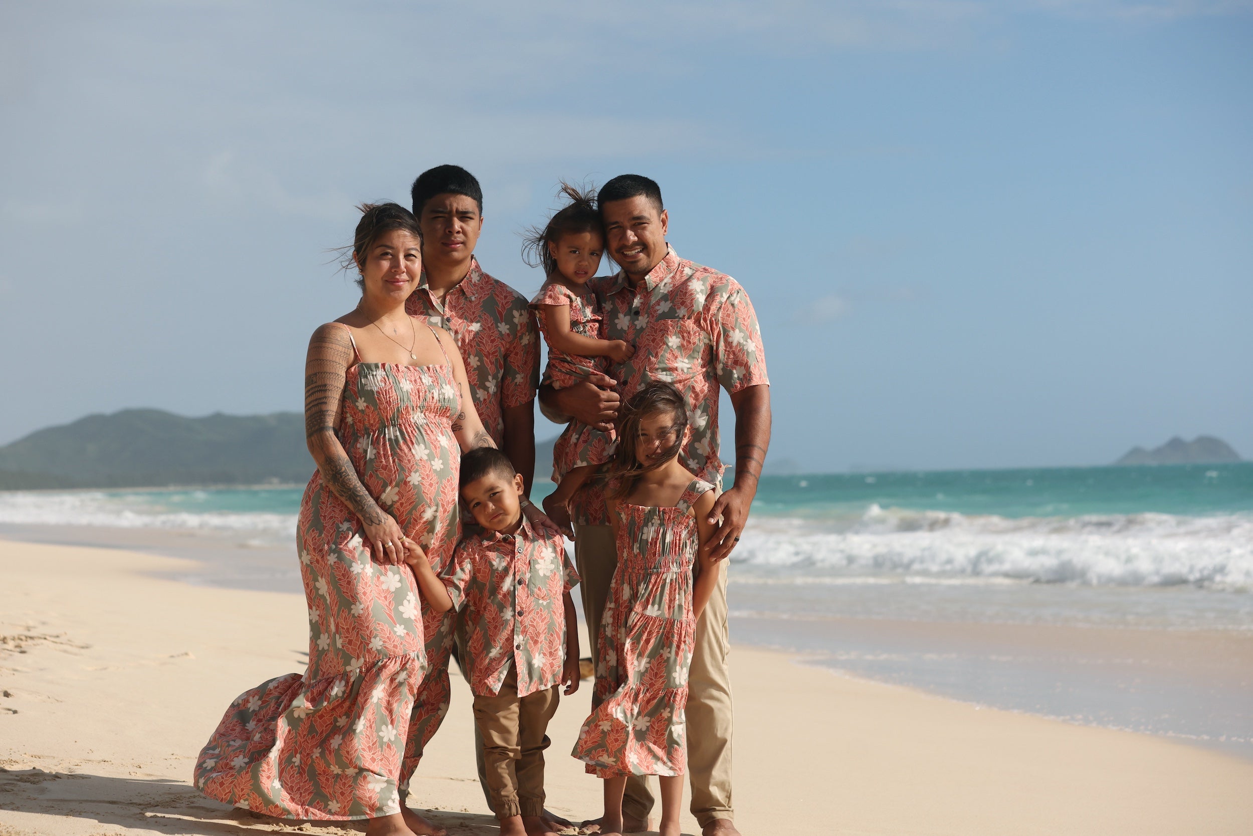 little boy wearing jade colored aloha button up with tiare ginger print