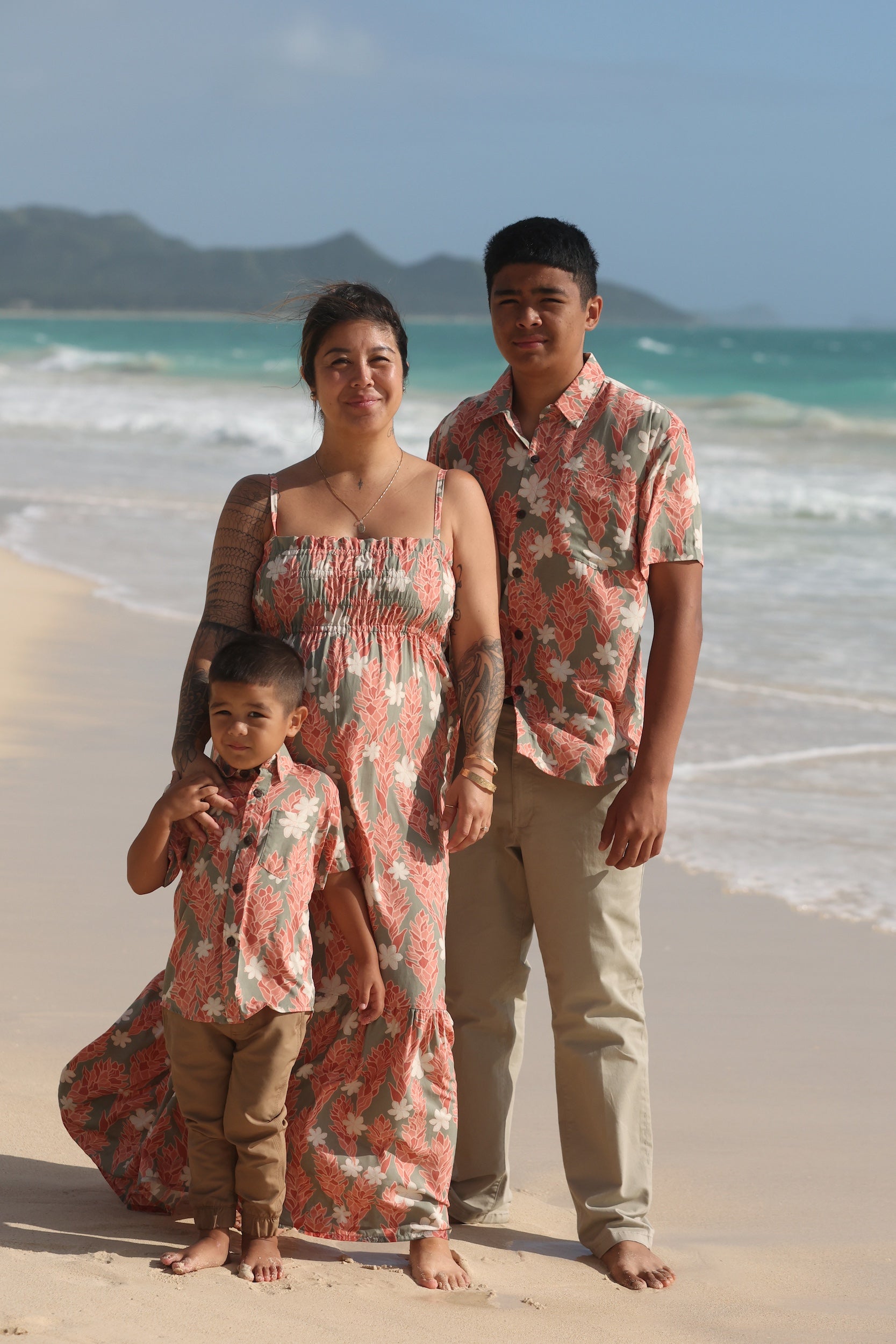 little boy wearing jade colored aloha button up with tiare ginger print
