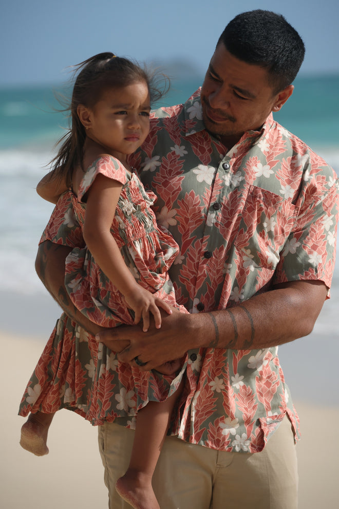 little girl wearing long jade color tiered dress with tiare ginger print