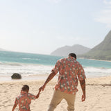 little boy wearing jade colored aloha button up with tiare ginger print